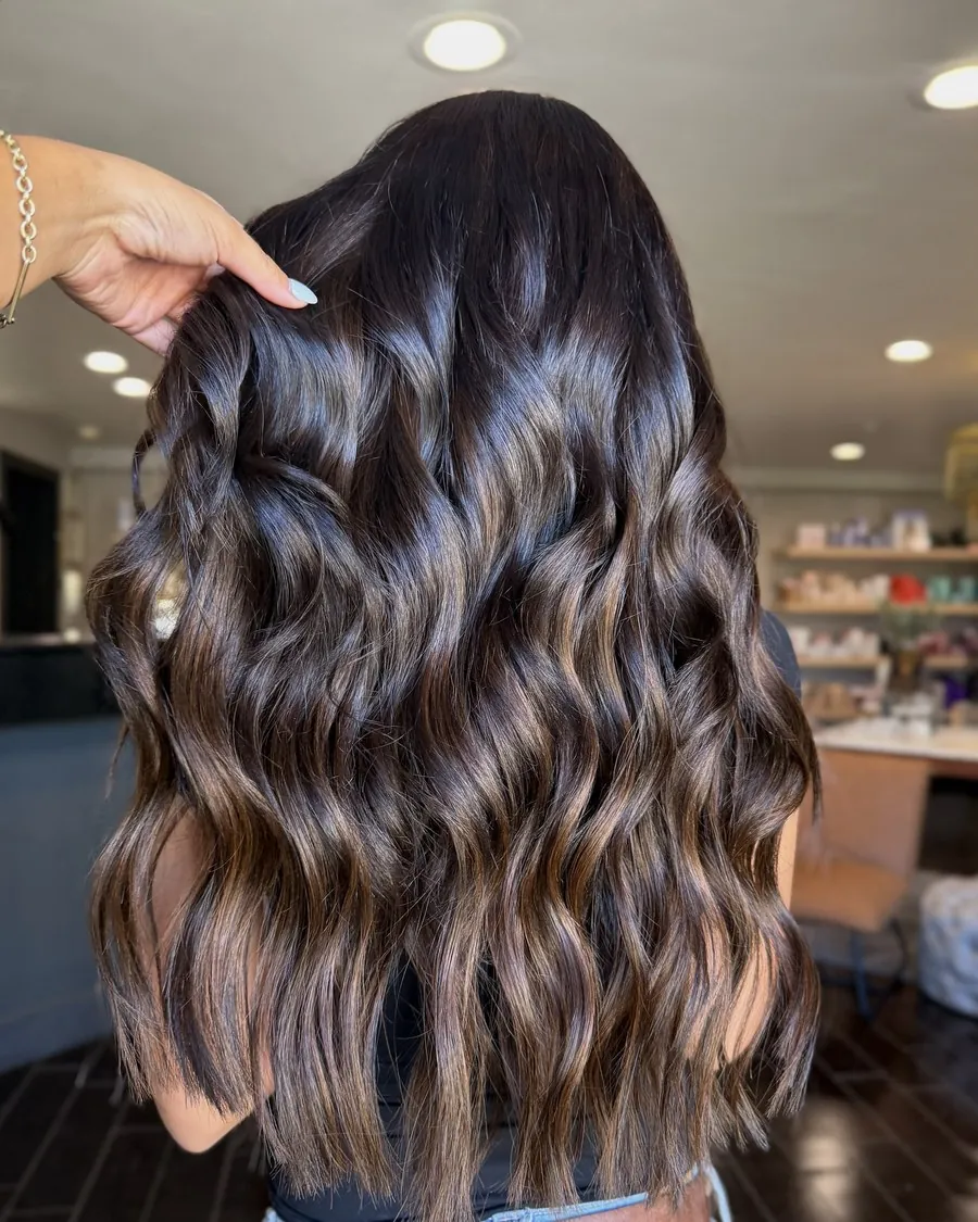 Long brunette extensions by Kirra Davis